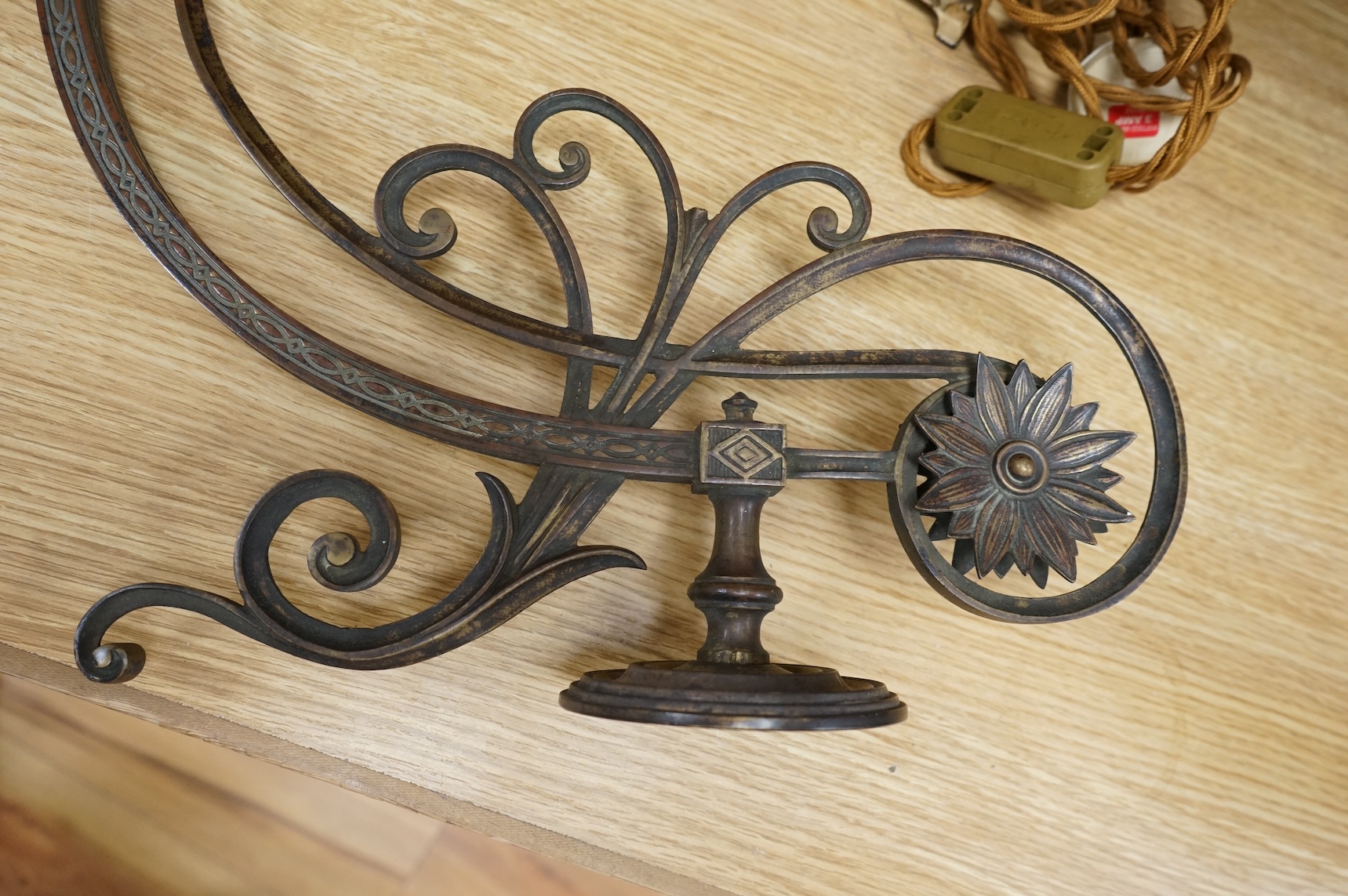 A cast brass wall sconce and a toleware two light lamp on onyx base, largest 46cm wide (2)
